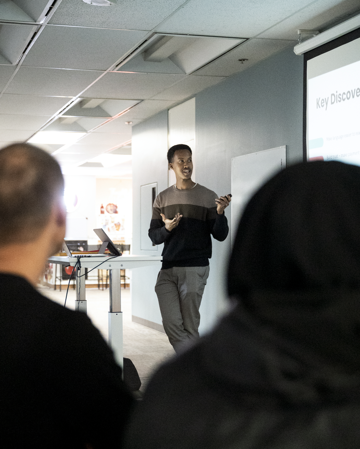 Uriel Karerwa presenting UX research findings to an audience